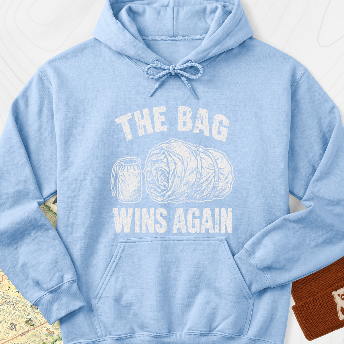 The Bag Wins Again Hoodie — Light Blue — Front print [studio:1aARvoT1muUcwNzR_H9EpYPfs8Ina5SFi]